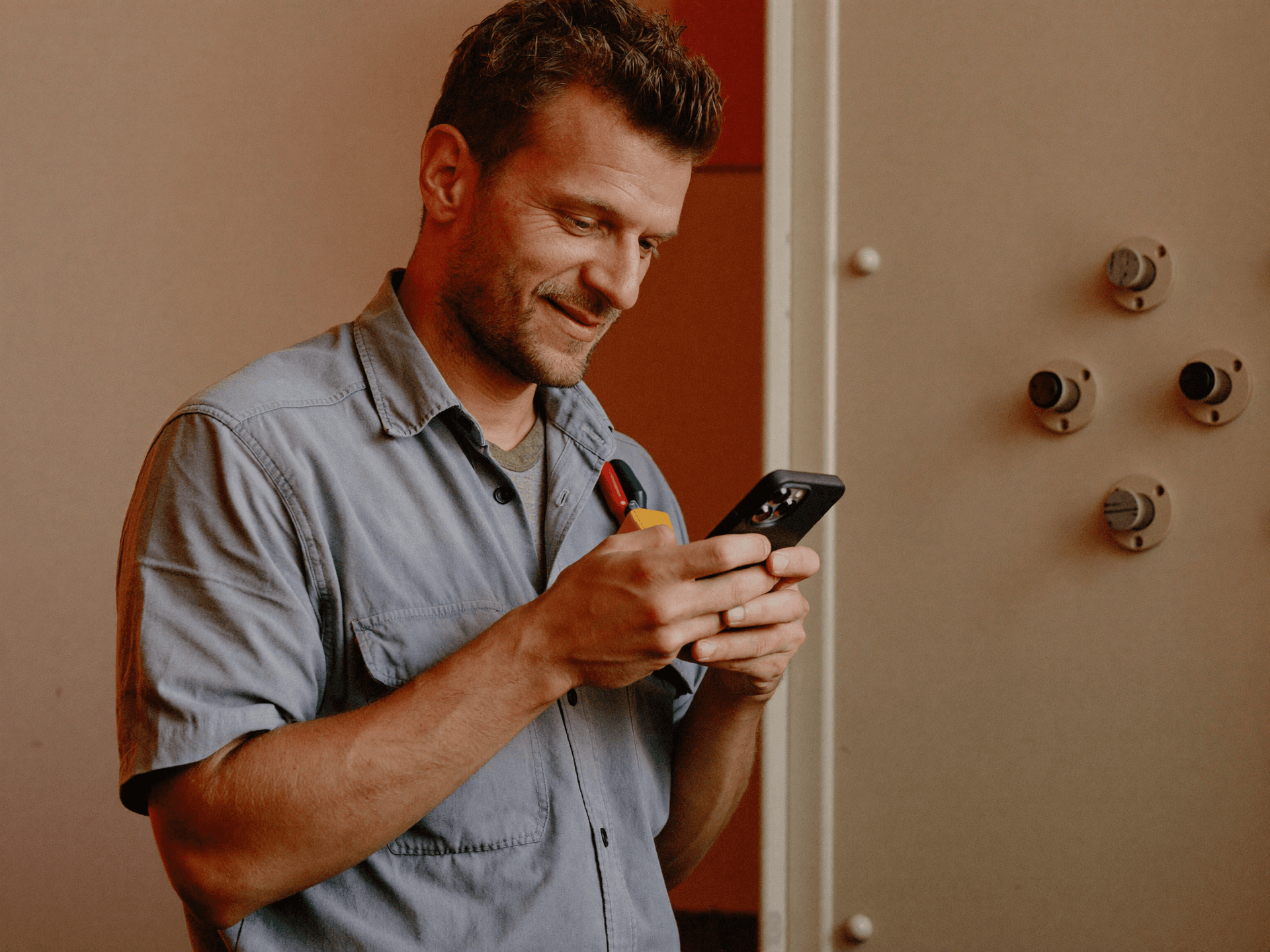A tradesperson checking a new lead on their phone
