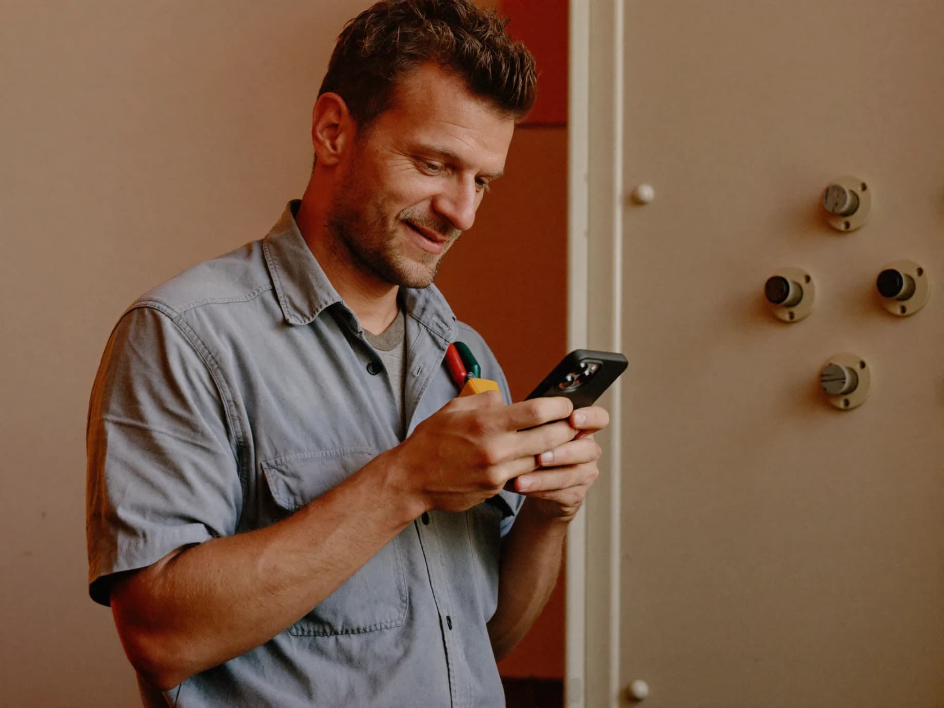 A tradesperson checking a new lead on their phone